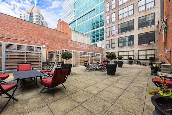 an outdoor patio with tables and chairs and tall buildings at Market Square Place, Pittsburgh, PA, 15222