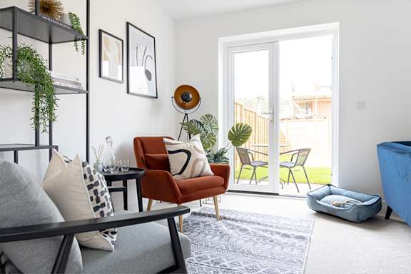 a living room with a couch and a glass table