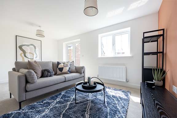 a living room with a couch and a glass table
