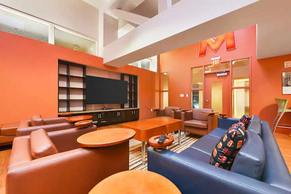 a room with couches and tables and a television at Market Square Place, Pittsburgh, PA, 15222