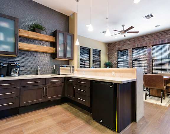 a living room with a kitchen and a balcony