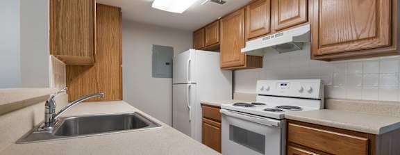 a large clubhouse kitchen and dining area with a fireplace and a table and chairs
