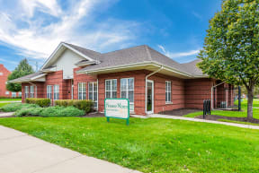 the front of a brick building with a sign in front of it at Horace Mann apartments and townhomes in Gary, IN