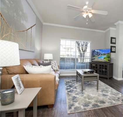 an open living room and dining room with a ceiling fan