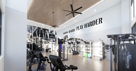 A gym with a variety of equipment and a sign that says "Work Hard Play Harder".