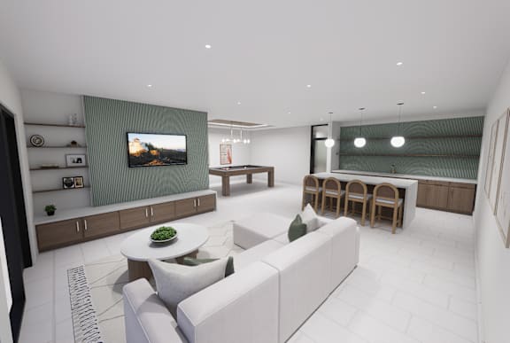 A modern living room with a white sofa and a television on the wall.