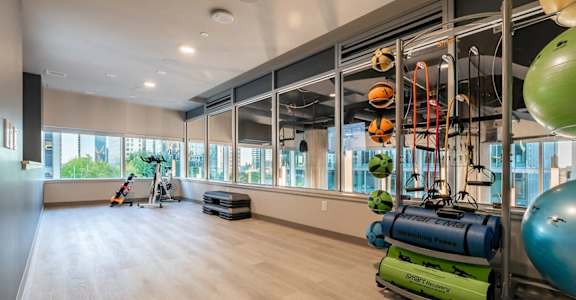 A gym with a variety of equipment including a green exercise ball.