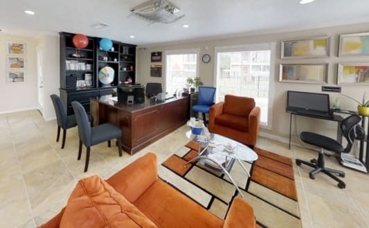 a living room filled with furniture and a desk