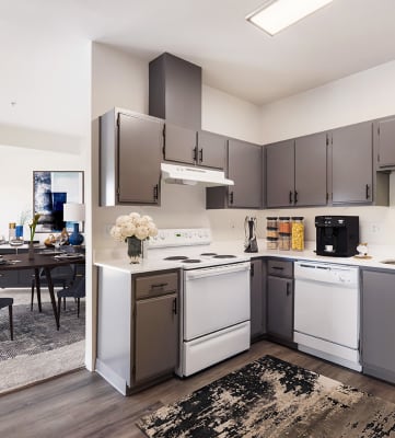 a kitchen with white appliances and gray cabinets at Shoreline Village, Washington, 99352