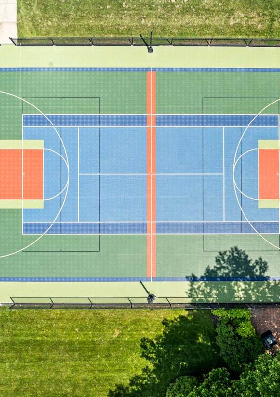 A basketball court with a blue and orange color scheme.