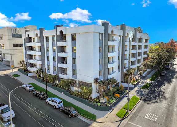 Exterior aerial view of an apartment building with cars parked. at Midvale Court Apartments Westwood, Los Angeles, 90024