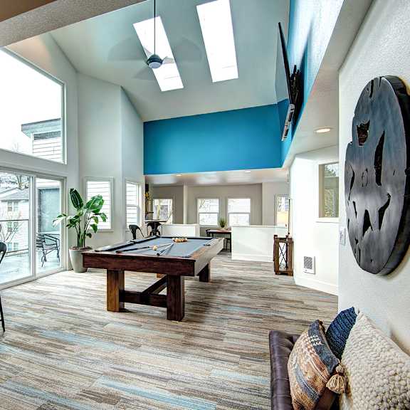 a game room with a pool table and a large window