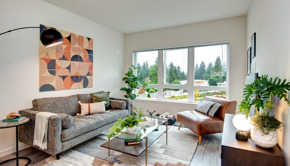 a living room with a couch and a chair and a window at Hazel Apartments, Edmonds, 98026