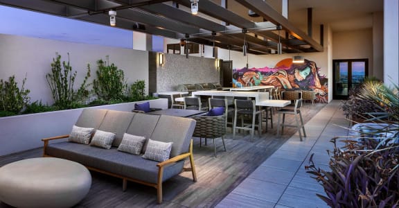 a rendering of a patio with tables and chairs and a mural