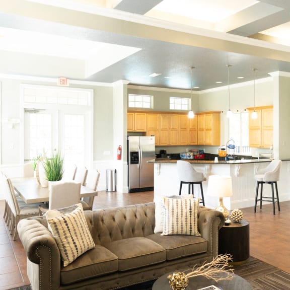 an open concept living room and dining area with a white dining table and rattan chairs