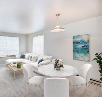 A living room with a white couch and a coffee table.