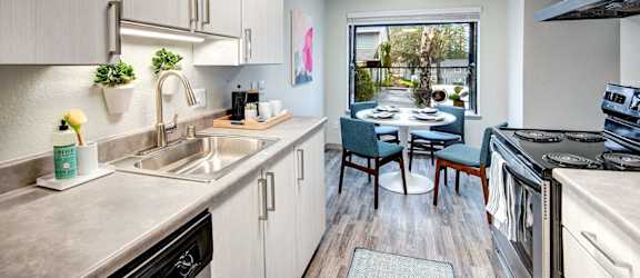 A kitchen with a table and chairs in the middle of the room.