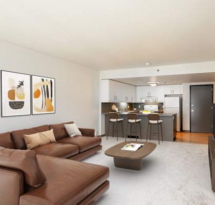 A living room with a brown couch and a coffee table.