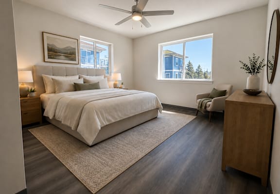 A bedroom with a large bed and a window overlooking a building.