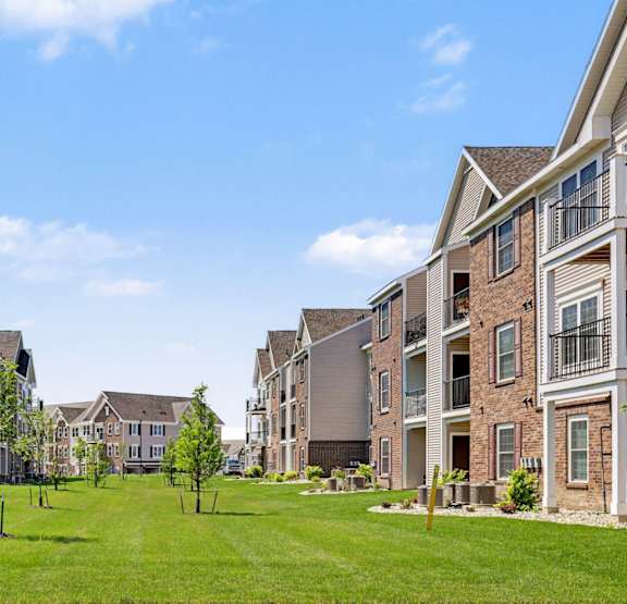 an exterior apartment building with balconies and garages at Meadowbrooke Apartment Homes, Grand Rapids, MI