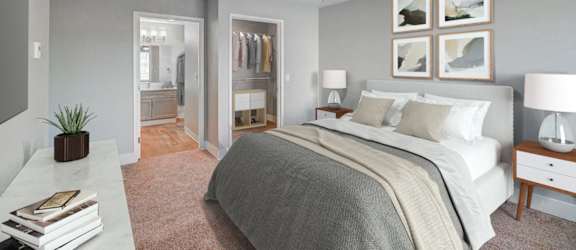 A bedroom with a large bed, a ceiling fan, and a clothing rack.