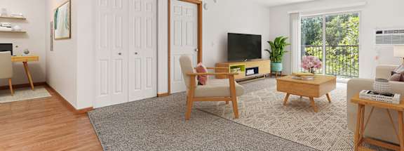 A living room with a grey carpet and wooden floors.