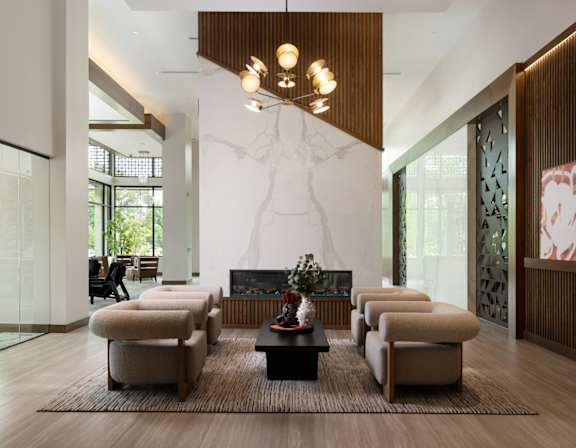 A modern living room with a fireplace and a large window.