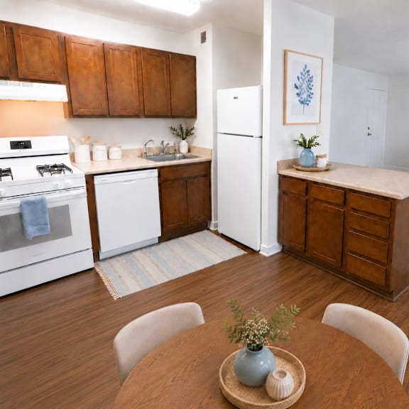 A kitchen with white appliances and wooden cabinets.