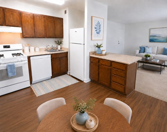A kitchen with white appliances and wooden cabinets.