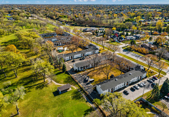 A bird's eye view of a residential area with houses and trees.