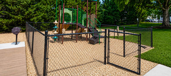 A playground with a swing set and a green dome-shaped structure.