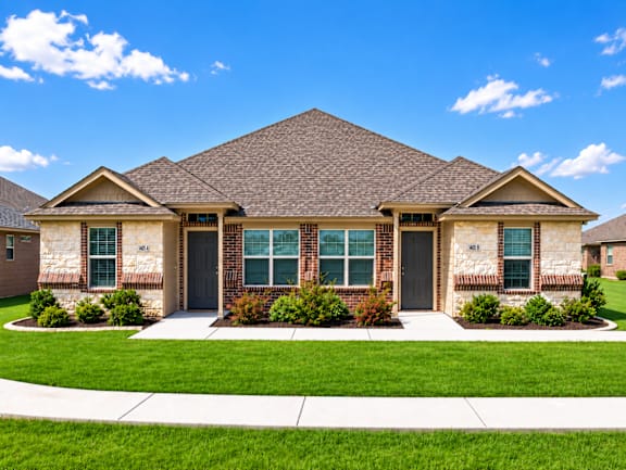 A house with a brown roof and a black front door.