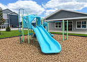 Thumbnail 4 of 10 - A blue slide in a playground with a green metal frame.