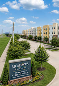 Meadows Nicholson apartment complex with a sign in front.
