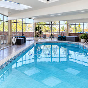 A large indoor swimming pool with a skylight above it.