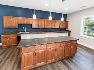A kitchen with wooden cabinets and a granite countertop.