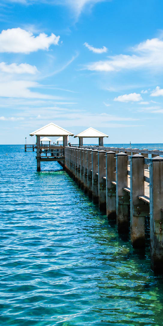 A wooden pier with a gazebo extends into the water.