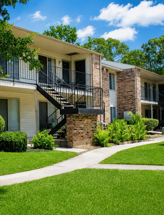 A sunny day at a residential area with apartment buildings and greenery.