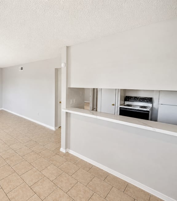 A room with a tiled floor and a window on the left side.