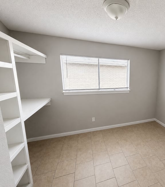 A room with a window and a staircase.