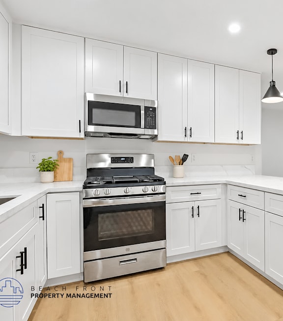 A well-lit, modern kitchen and living room with a dining area.