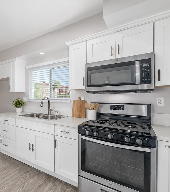 A well-lit, modern kitchen and living room with a dining area.