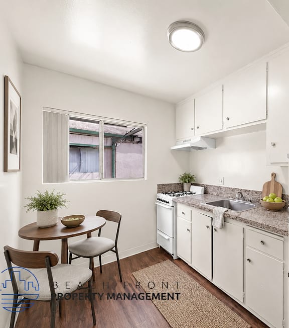 A well-lit, modern kitchen and living room with a dining area.