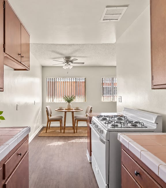 A well-lit, modern kitchen and living room with a dining area.