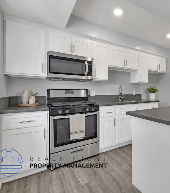 A well-lit, modern kitchen and living room with a dining area.