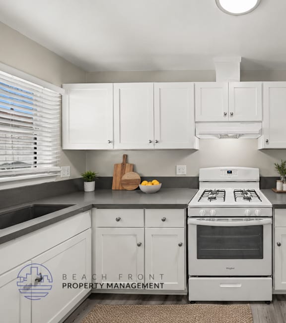 A well-lit, modern kitchen and living room with a dining area.