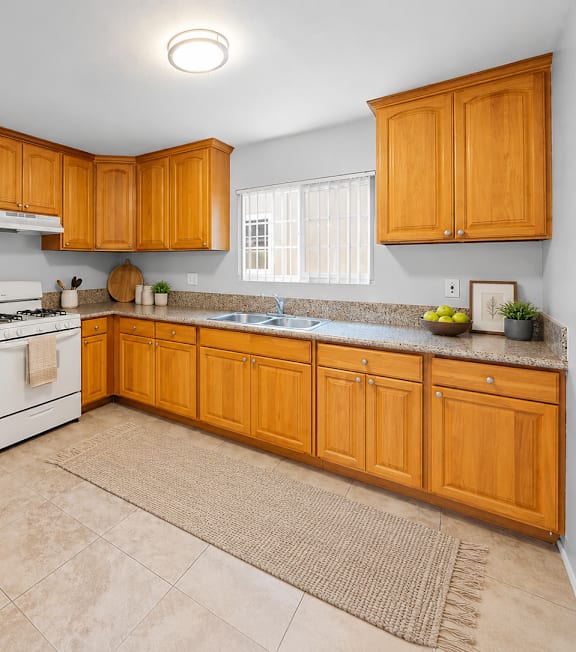 A well-lit, modern kitchen and living room with a dining area.