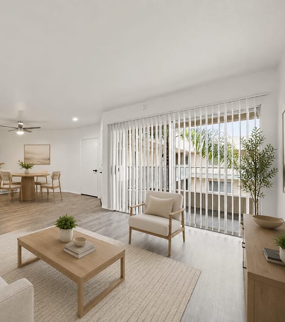 A well-lit, modern kitchen and living room with a dining area.