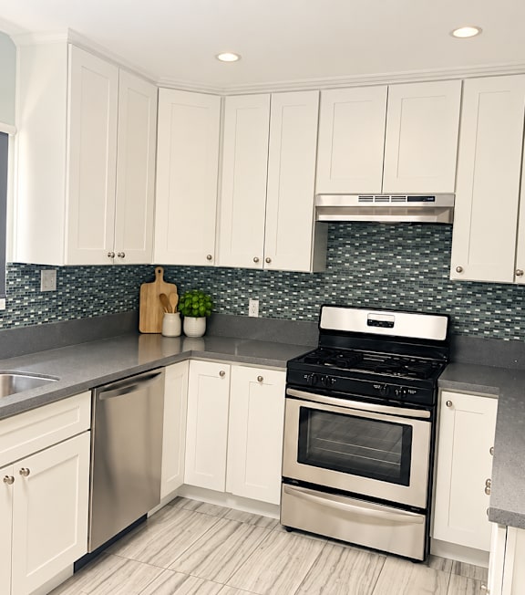 A well-lit, modern kitchen and living room with a dining area.