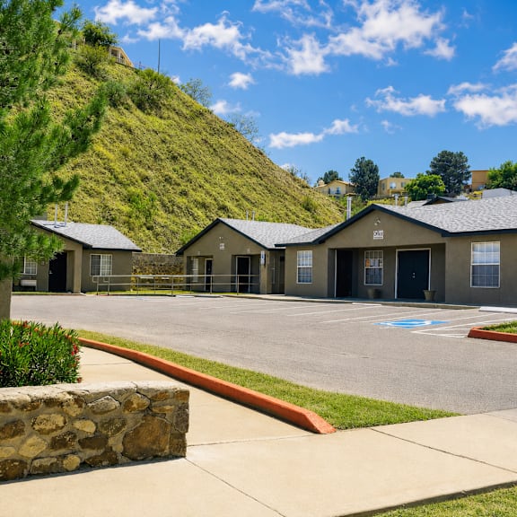 A row of houses with a hill in the background.